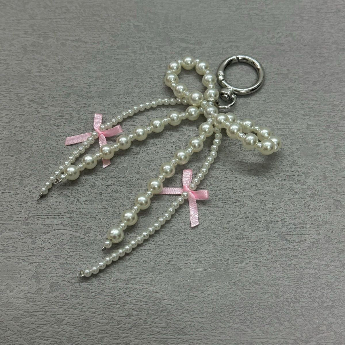 Korean Pearl Bow Phone Charm – Stylish & Feminine